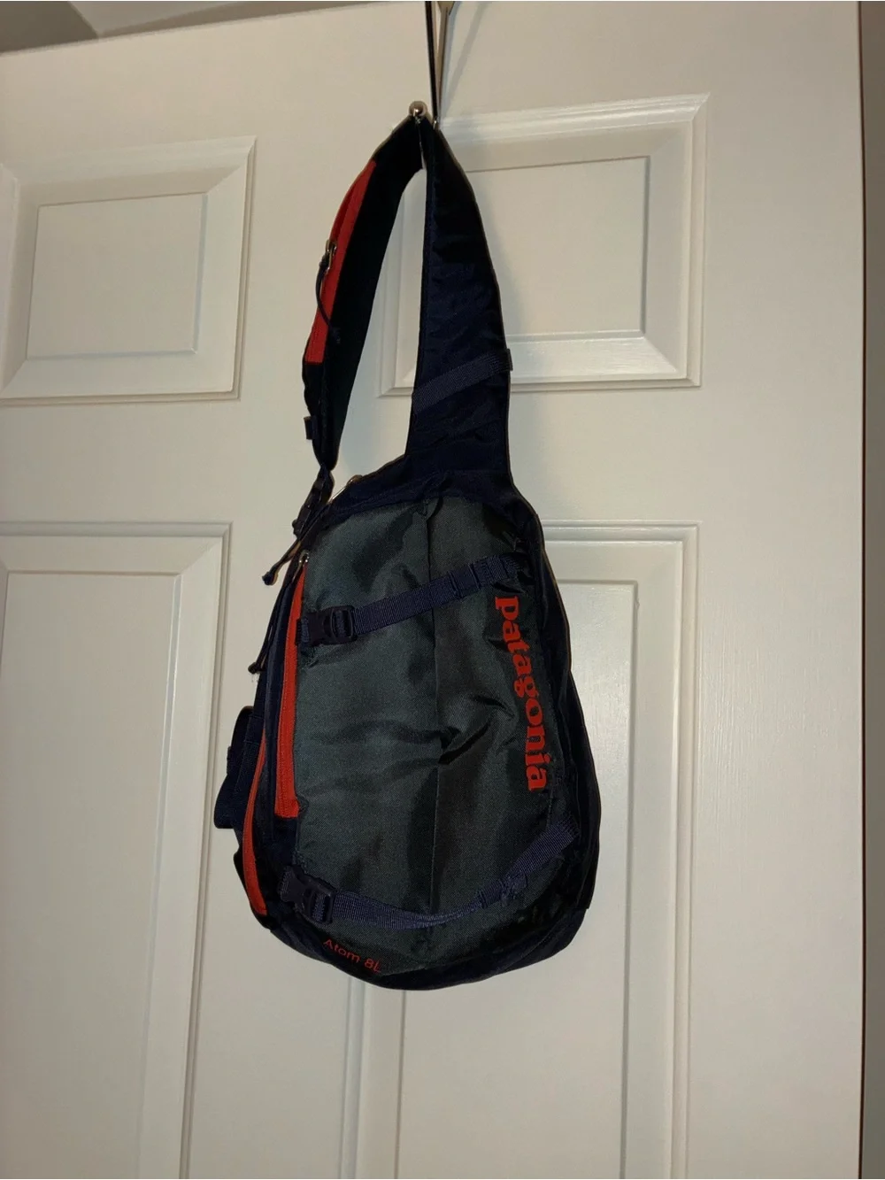 Patagonia Atom Sling 8L crossbody pack in a navy blue